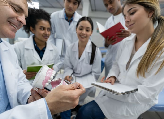 Group of students in an dental health class at medical school  - education concepts